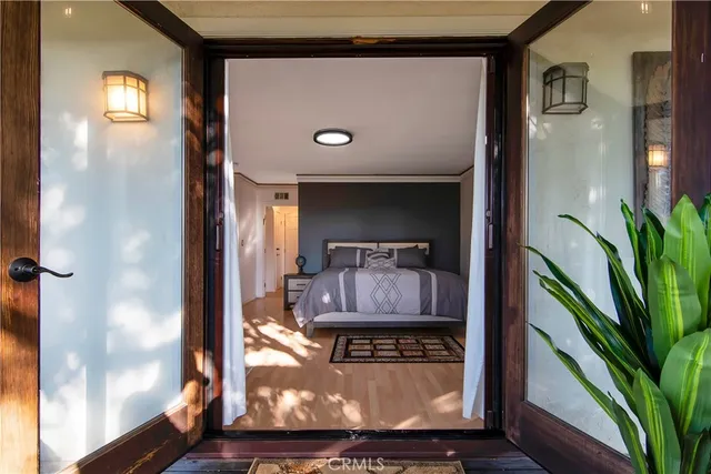 a bedroom with a bed and a large window