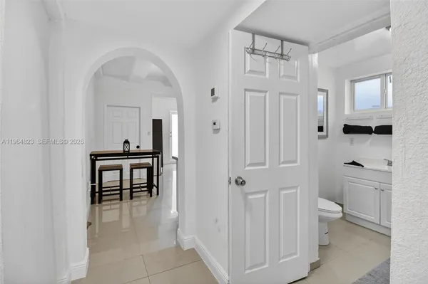 a kitchen with a refrigerator and a sink