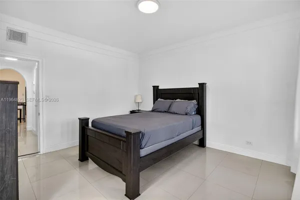 a bedroom with a bed and a television