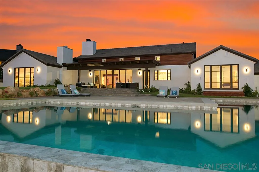16582 Rio Vista Road San Diego, CA 92127 - Photo 1 of 20 a view of a house with pool and a pond