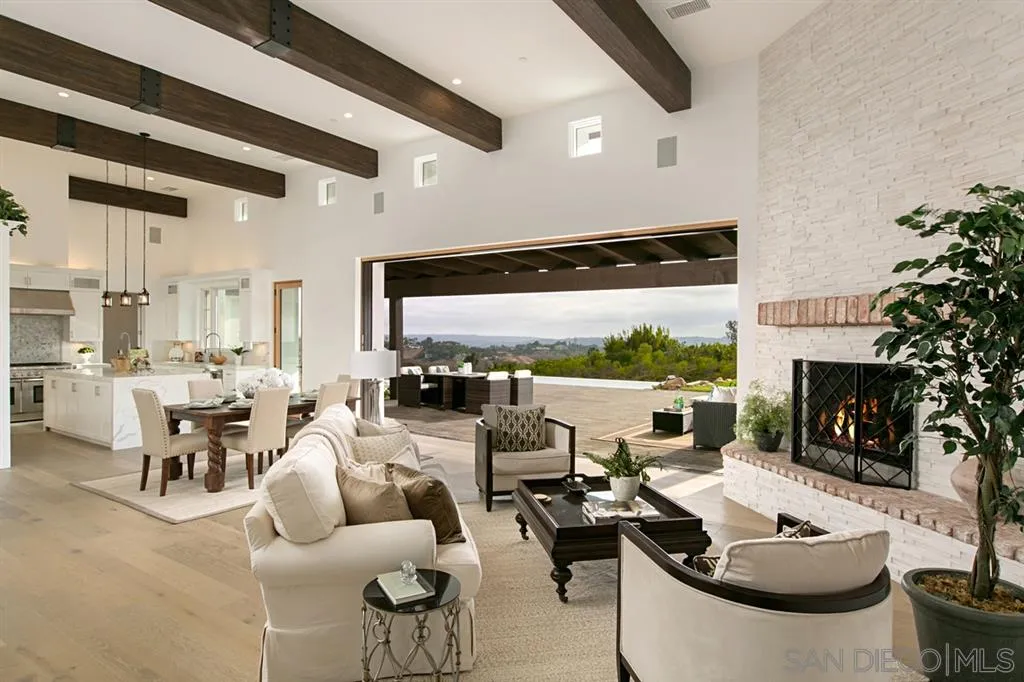 16582 Rio Vista Road San Diego, CA 92127 - Photo 4 of 20 a living room with furniture fireplace and a large window