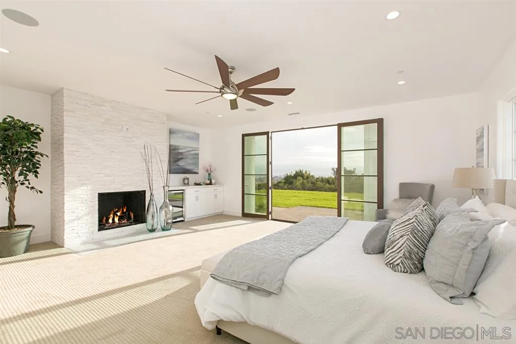 16582 Rio Vista Road San Diego, CA 92127 - Photo 8 of 20 a bed room with a bed and a fireplace