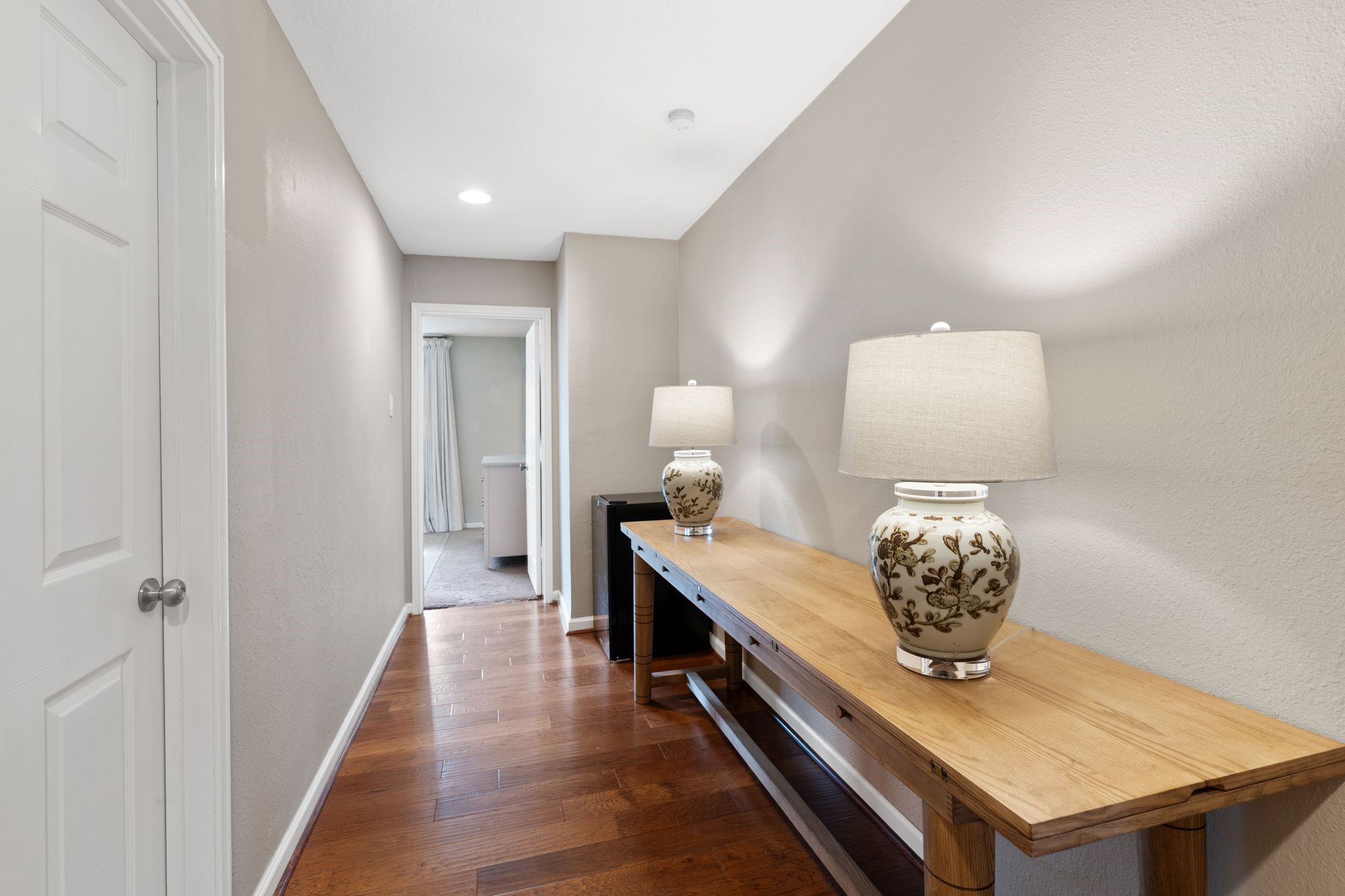 991 Curtin Street Houston, TX 77018 - Photo 16 of 39 A long hallway in the bedorom wing is a blank slate for your families needs. This space could be a fantastic built in homework station, additional storage for the primary, or a built in hallway linen closet.