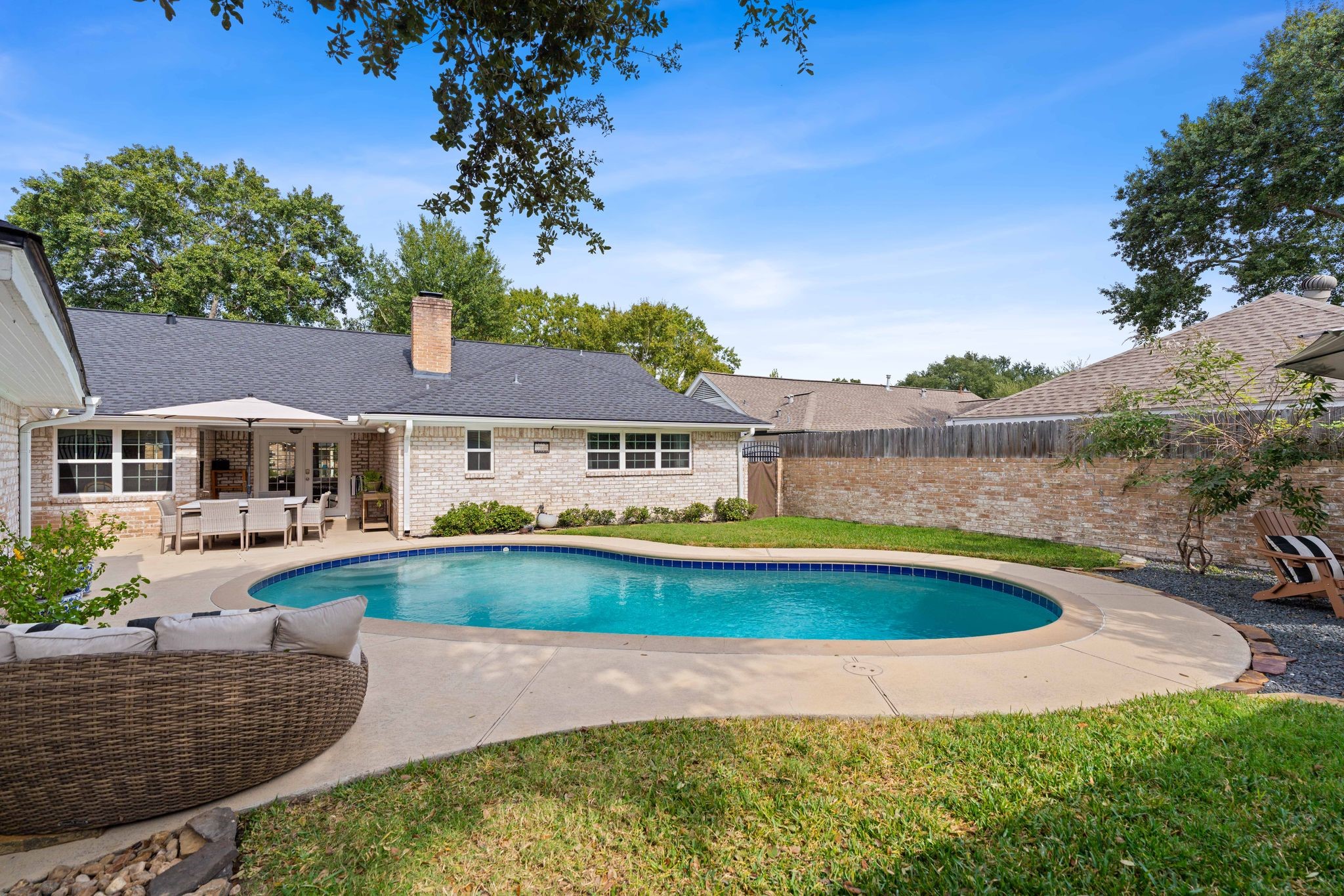 991 Curtin Street Houston, TX 77018 - Photo 2 of 39 The refreshing pool is the centerpiece of the backyard but provides plenty of room for pups and little ones to still play in the grass.