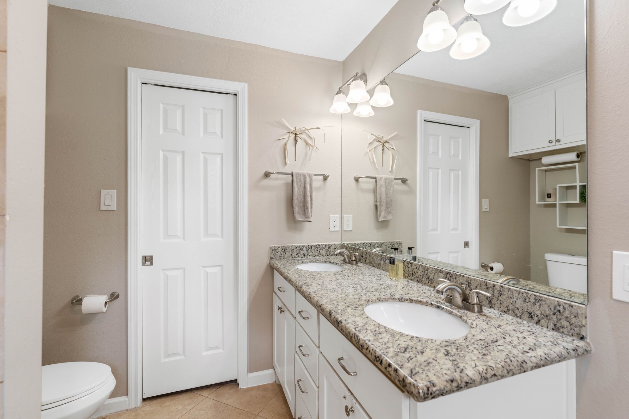 991 Curtin Street Houston, TX 77018 - Photo 22 of 39 a bathroom with a granite countertop sink a toilet and a mirror
