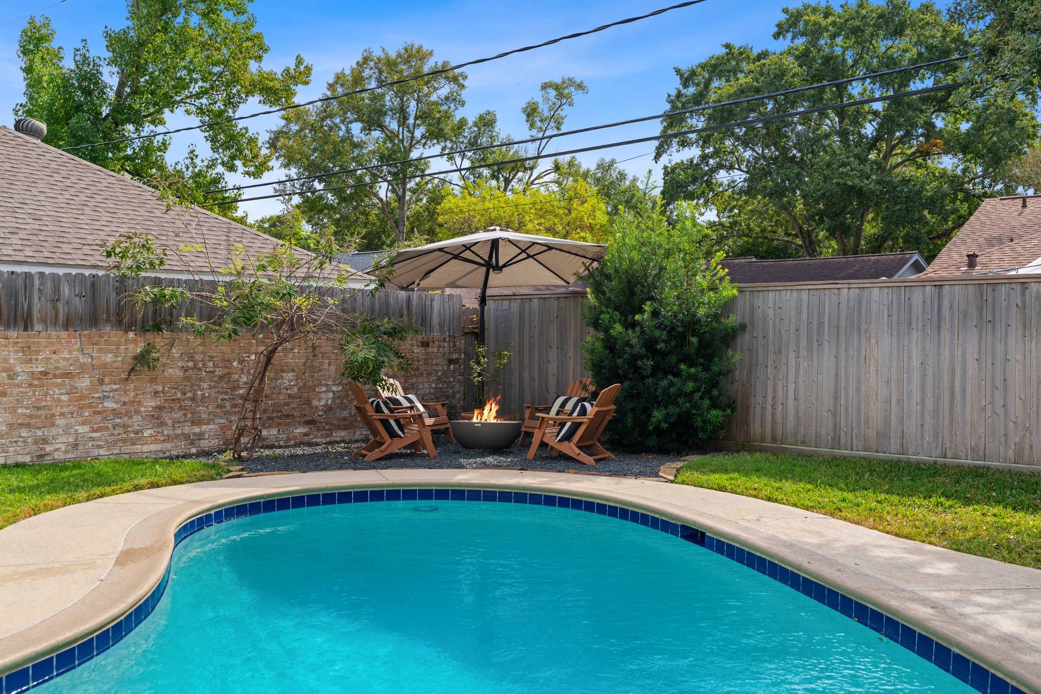 991 Curtin Street Houston, TX 77018 - Photo 29 of 39 This backyard is meant for entertaining with its pool, fire pit and grass area for pets to play.