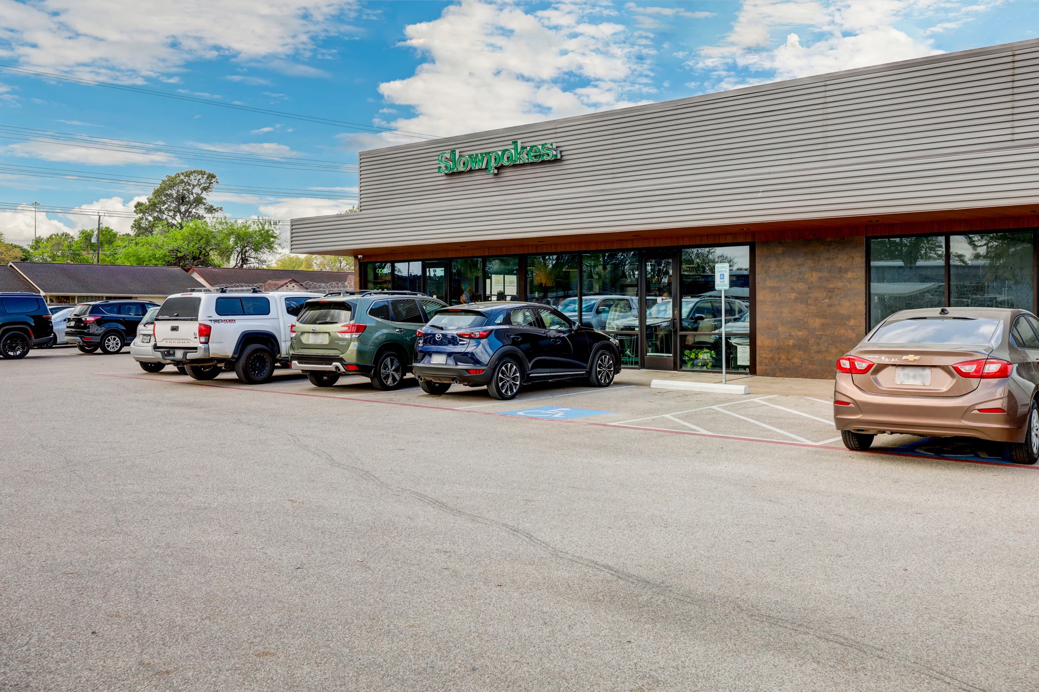991 Curtin Street Houston, TX 77018 - Photo 35 of 39 Serving up a rotating variety of coffees, beers, and wines, Slowpokes boasts a well-rounded atmosphere for an early morning latte or happy hour glass of pinot, perfectly paired with local pastries or cheese board.