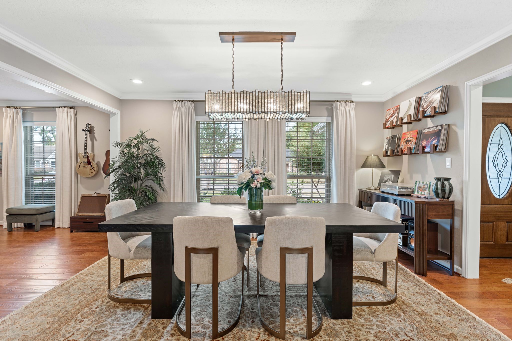 991 Curtin Street Houston, TX 77018 - Photo 4 of 39 Just off of the foyer is the stunning formal dining space with stylish linear chandelier. This space offers crown molding, 2 inch wood blinds, engineered hardwood flooring and a warm neutral color palette.