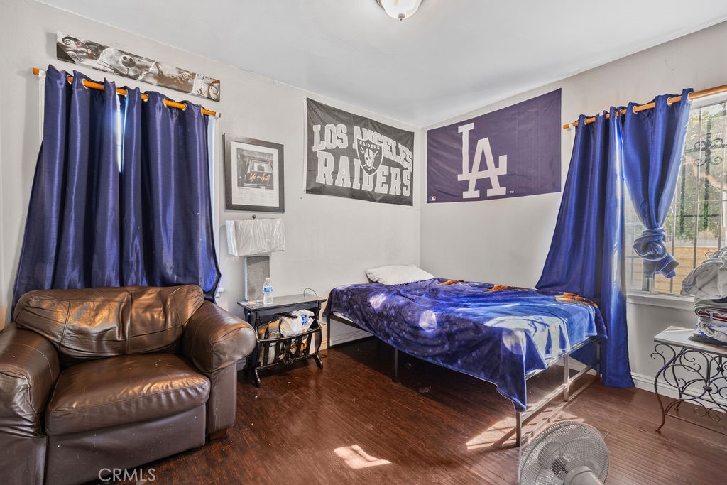 4237 Abbott Road Lynwood, CA 90262 - Photo 14 of 39 a bedroom with a bed couch and a window