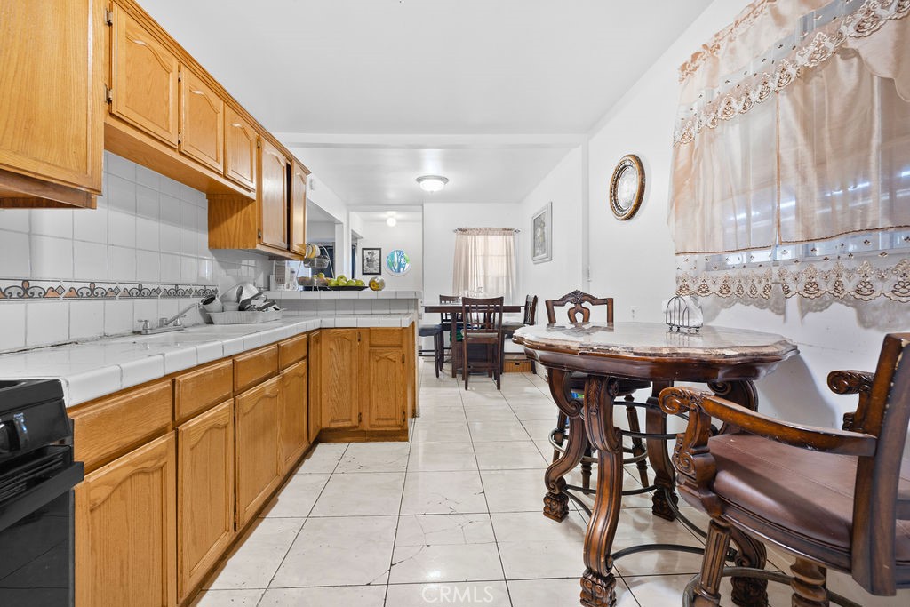4237 Abbott Road Lynwood, CA 90262 - Photo 17 of 39 a kitchen with stainless steel appliances kitchen island granite countertop a sink and cabinets