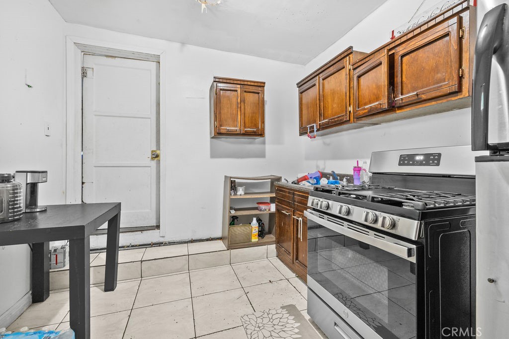 4237 Abbott Road Lynwood, CA 90262 - Photo 19 of 39 a kitchen with stainless steel appliances granite countertop a stove and a refrigerator