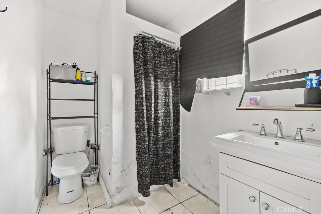 4237 Abbott Road Lynwood, CA 90262 - Photo 21 of 39 a bathroom with a sink toilet and shower