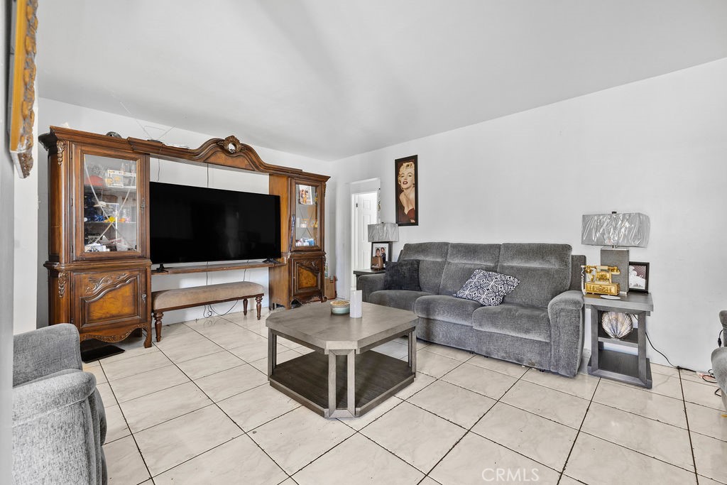 4237 Abbott Road Lynwood, CA 90262 - Photo 5 of 39 a living room with furniture and a flat screen tv