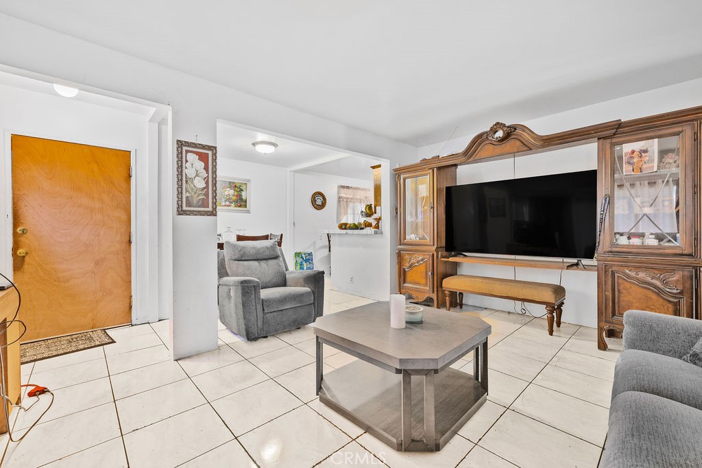 4237 Abbott Road Lynwood, CA 90262 - Photo 6 of 39 a living room with furniture and a flat screen tv