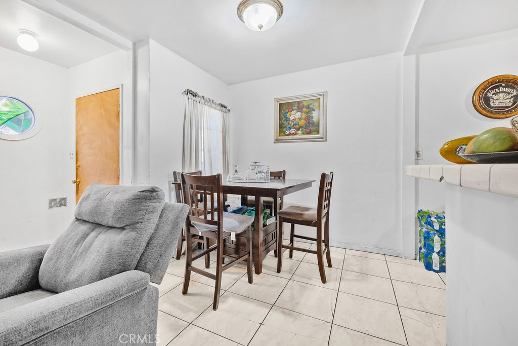 4237 Abbott Road Lynwood, CA 90262 - Photo 7 of 39 a dining room with furniture and wooden floor