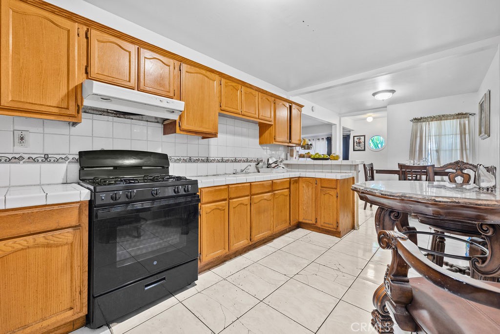 4237 Abbott Road Lynwood, CA 90262 - Photo 9 of 39 a kitchen with a sink appliances and cabinets