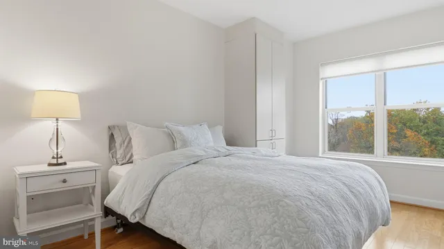 a bedroom with a bed and a lamp