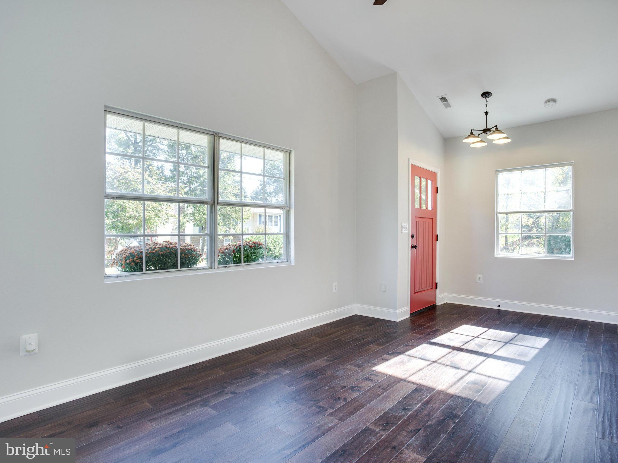 1704 Forestville Road Edgewater, MD 21037 - Photo 6 of 24 an empty room with wooden floor and windows