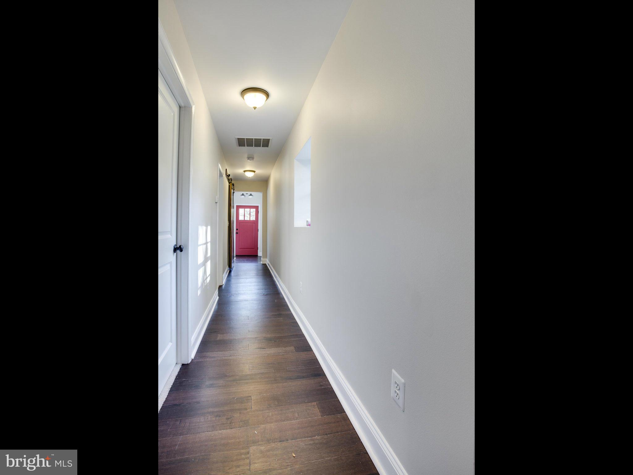 1704 Forestville Road Edgewater, MD 21037 - Photo 9 of 24 a view of a hallway with wooden floor