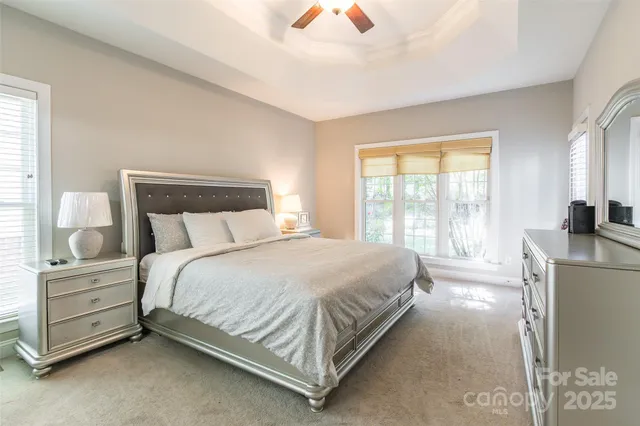 a large bed sitting in a bedroom next to a window