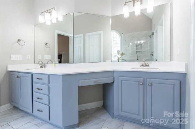 a bathroom with a sink vanity and a mirror