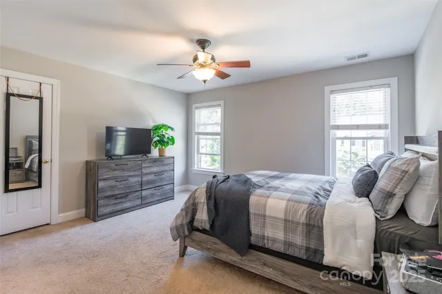 a bedroom with a bed and a chandelier