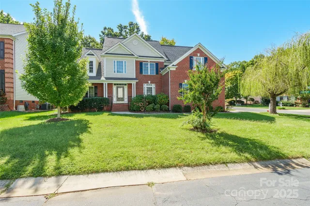 a front view of house with yard and green space