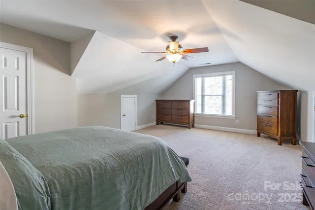 a spacious bedroom with a bed dresser and a window