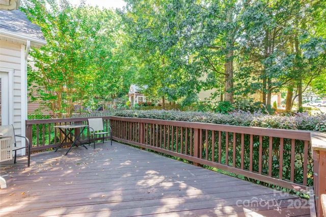 a view of a two chairs and table in the back yard