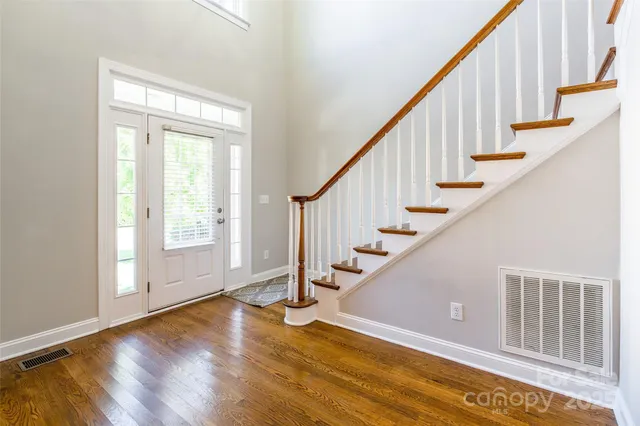 a view of an entryway with wooden floor and door