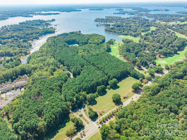 an aerial view of a houses with a yard