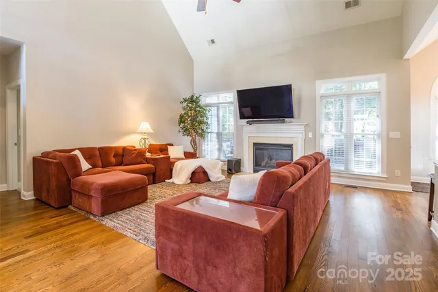 a living room with fireplace furniture and a flat screen tv