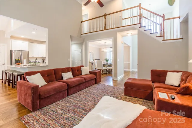 a living room with furniture a table and a painting