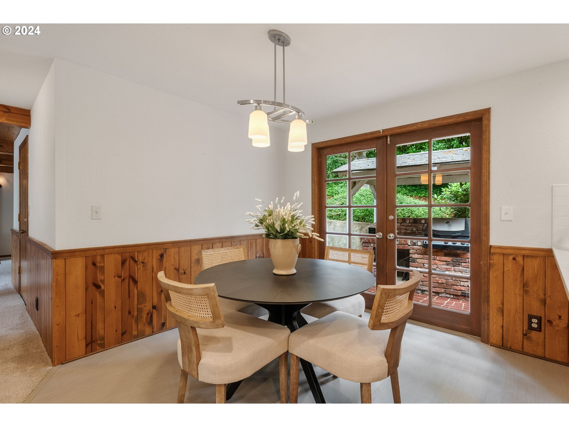 1995 West 34th Avenue Eugene, OR 97405 - Photo 12 of 47 a dining room with furniture a chandelier and wooden floor