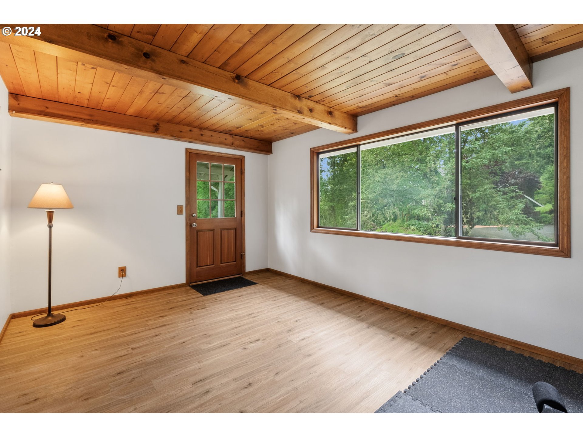 1995 West 34th Avenue Eugene, OR 97405 - Photo 35 of 47 a view of an empty room with wooden floor and a window