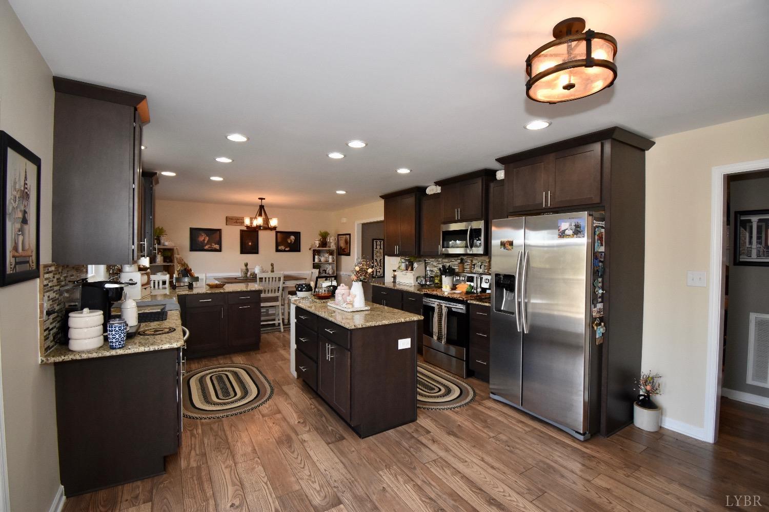 224 Tweedy Road Concord, VA 24538 - Photo 23 of 62 a kitchen with a refrigerator and a stove top oven