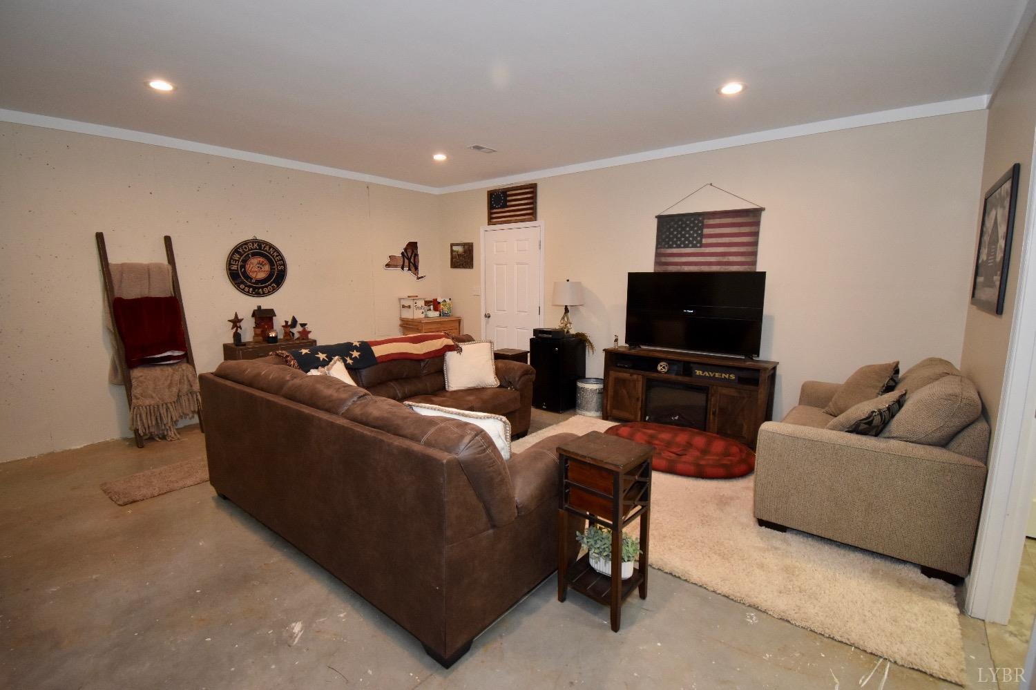 224 Tweedy Road Concord, VA 24538 - Photo 40 of 62 a living room with furniture and a flat screen tv