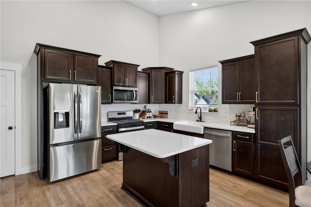 128 Whitman Way Easley, SC 29642 - Photo 9 of 34 This kitchen features rich cabinetry, sleek countertops, and modern appliances.