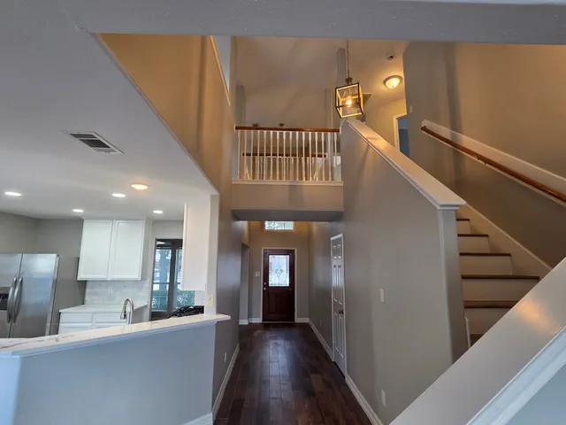 a view of a hallway with a kitchen