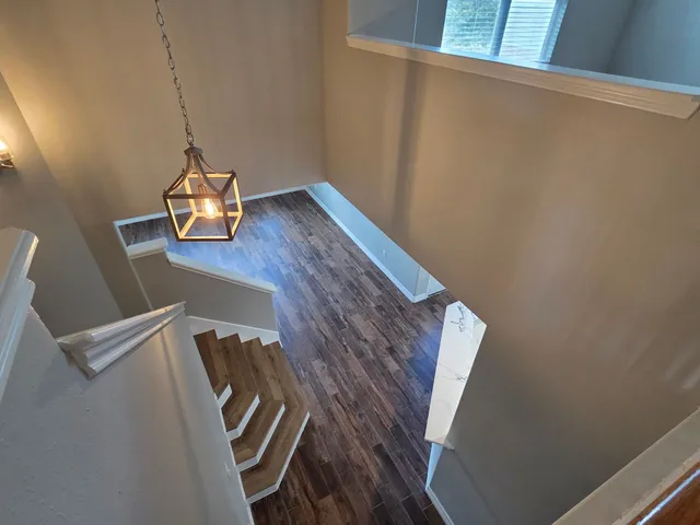 a view of a room with wooden floor
