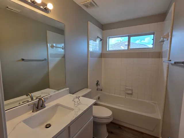 a bathroom with a sink toilet tub and shower