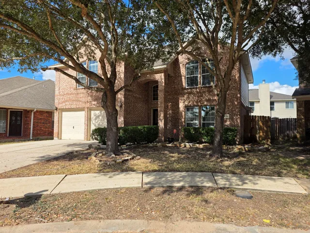 a view of a house with a yard covered in snow