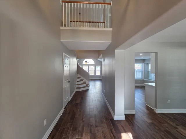wooden floor in a hall with a window