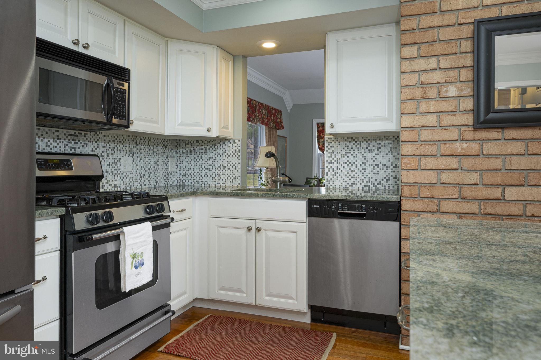 207 Overcreek Road Phoenixville, PA 19460 - Photo 13 of 47 a kitchen with stainless steel appliances granite countertop a stove microwave and sink