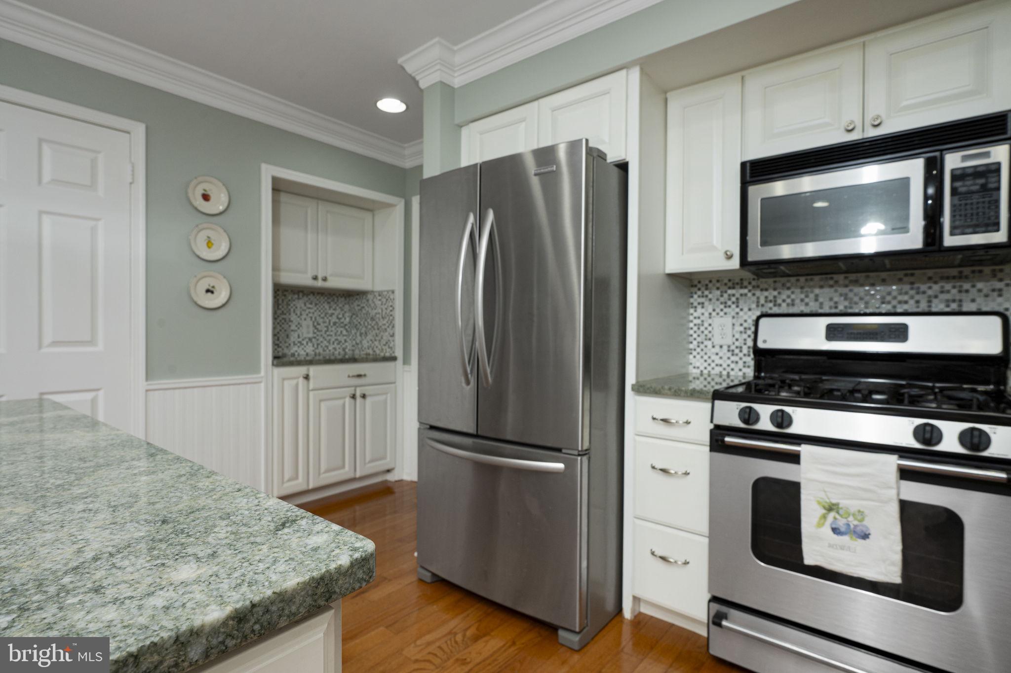 207 Overcreek Road Phoenixville, PA 19460 - Photo 14 of 47 a kitchen with granite countertop a refrigerator stove and microwave