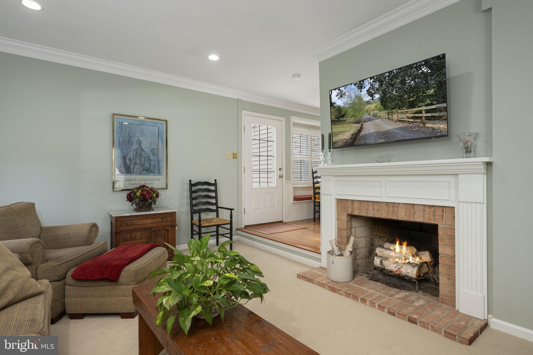 207 Overcreek Road Phoenixville, PA 19460 - Photo 18 of 47 a living room with furniture a fireplace and a flat screen tv
