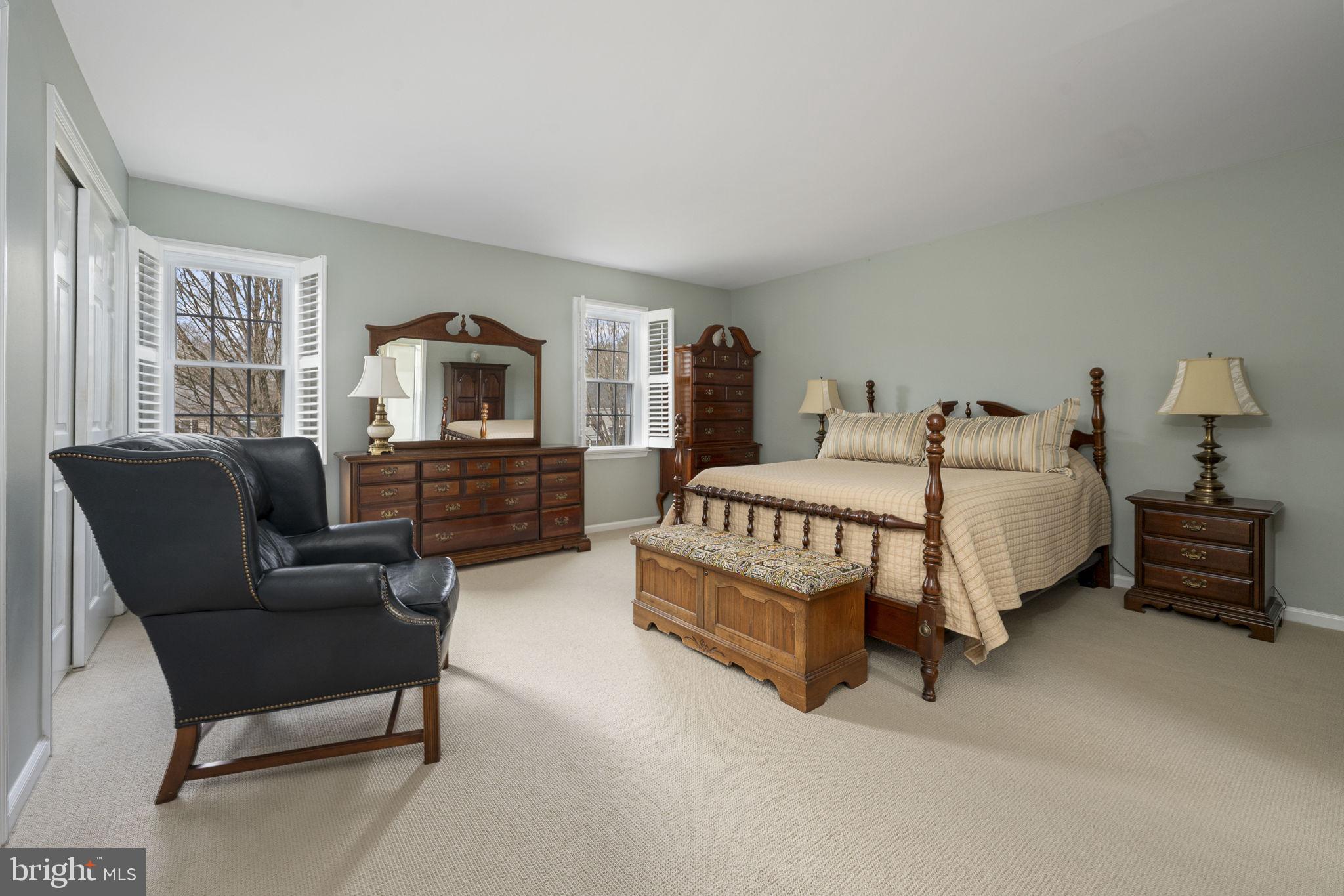 207 Overcreek Road Phoenixville, PA 19460 - Photo 23 of 47 a bedroom with a bed a couch and dresser next to a window