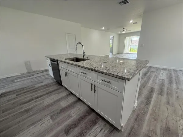 a kitchen with sink and mirror