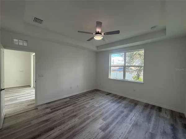 wooden floor in an empty room with a window