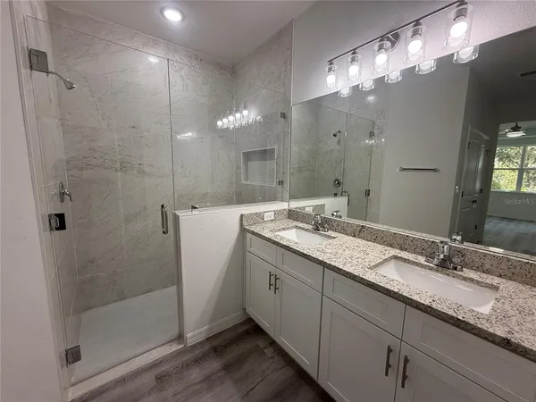 a bathroom with a double vanity sink and a mirror